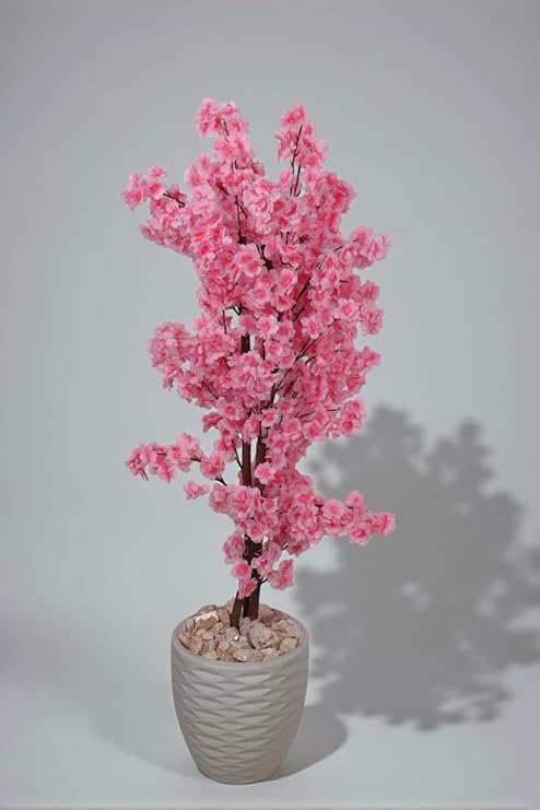 Artificial jasmine plant, 150 cm tall, with a dense, three-stemmed design. A realistic artificial tree for indoor and outdoor use, complete with a plastic pot, pebbles, and lush foliage. Pink color.