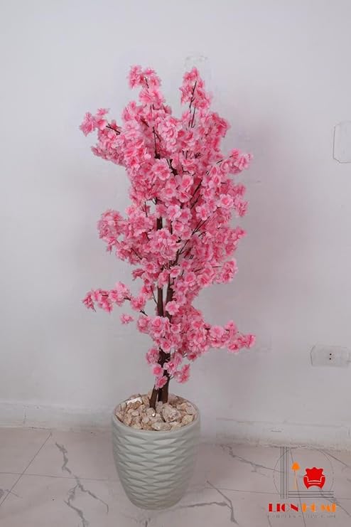 Artificial jasmine plant, 150 cm tall, with a dense, three-stemmed design. A realistic artificial tree for indoor and outdoor use, complete with a plastic pot, pebbles, and lush foliage. Pink color.