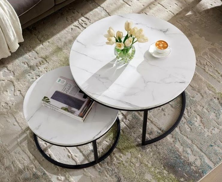 A center table made of two pieces of metal and marble wood.